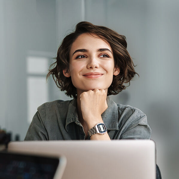 eine Frau sitzt an einem Schreibtisch mit einem Laptop